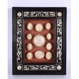 A 19TH CENTURY FRAMED SET OF COUNTRY HOUSE PLASTER INTAGLIOS contained within an Italian ebonised