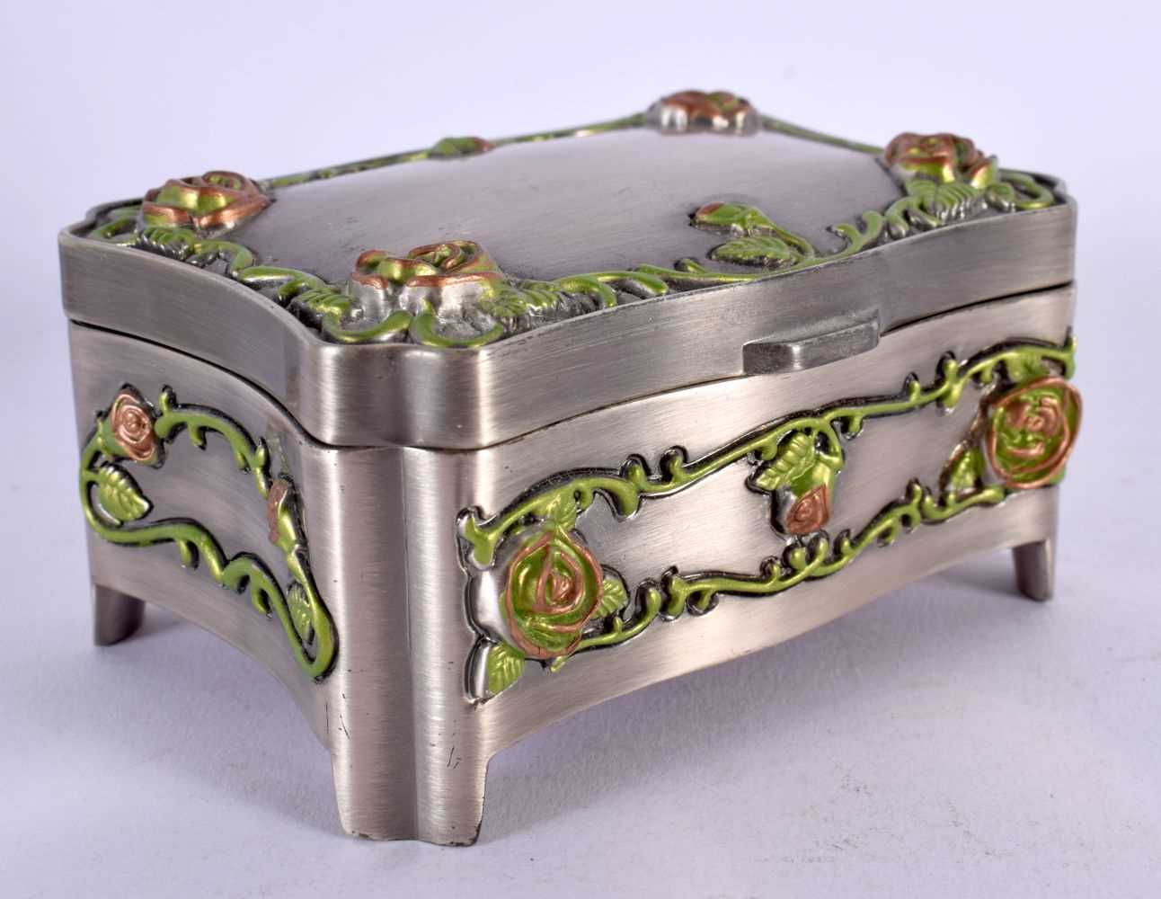 AN UNUSUAL ENAMELLED WHITE METAL JEWELLERY BOX overlaid with foliage and vines. 381 grams. 10 cm x 7