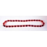 A CHERRY AMBER TYPE NECKLACE. 205 grams. 88 cm long.