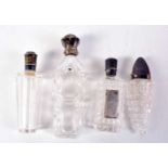 FOUR ANTIQUE SILVER TOPPED SCENT BOTTLES. Largest 12 cm x 3 cm. (4)