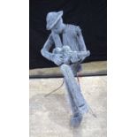 A twisted wire sculpture of a seated man playing a ukulele 92 cm .