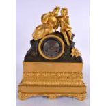 A 19TH CENTURY FRENCH GILT BRONZE MANTEL CLOCK formed with lovers within a landscape. 34 cm x 22