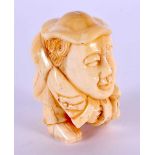 A JAPANESE CARVED BONE MAN NETSUKE. 5 cm x 3.5 cm.