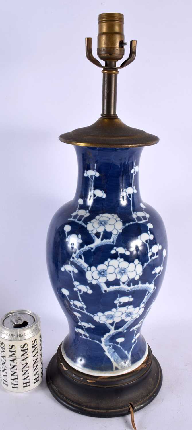 A 19TH CENTURY CHINESE BLUE AND WHITE PORCELAIN LAMP painted with flowers. 50 cm high.