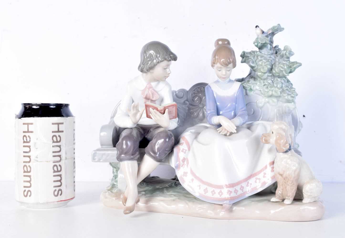 A Lladro group (5442) boy and girl on a bench. 24 x 24cm.