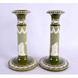 A RARE PAIR OF CARLTONWARE IMITATION JASPERWARE CANDLESTICKS overlaid with classical figures. 22