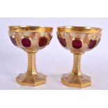 A PAIR OF 19TH CENTURY BOHEMIAN GILT AND CRANBERRY GLASS GOBLETS bearing label to base Alexander I