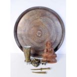A large Egyptian copper charger together with other metal items and a South East Asian wooden Buddha