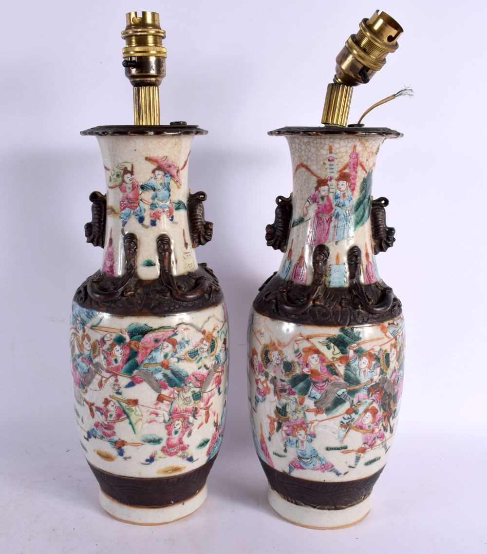 A PAIR OF 19TH CENTURY CHINESE CRACKLE GLAZED PORCELAIN LAMPS painted with warriors. 38 cm high.