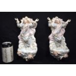 A pair of porcelain wall pockets depicting Jesus. 28cm (2).
