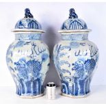 A large pair of octagonal sided blue and white porcelain lidded vases decorated with beasts and