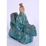 A 19TH CENTURY CHINESE TURQUOISE GLAZED POTTERY FIGURE Qing, modelled seated upon a bird. 16 cm x 12