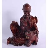 A LATE 19TH CENTURY CHINESE CARVED HARDWOOD FIGURE OF A MALE Qing, modelled beside a tiger. 22 cm