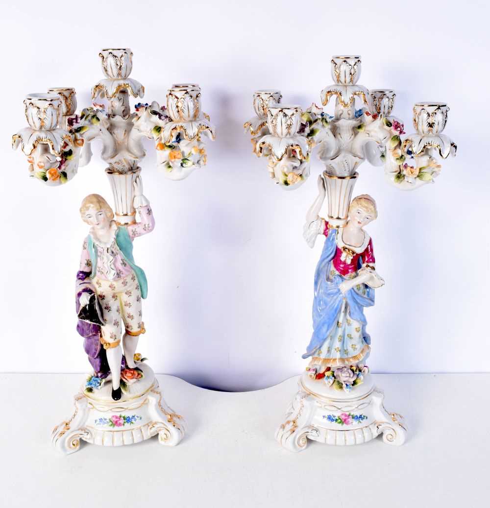 A pair of Continental figural porcelain candlesticks 47 cm (2).