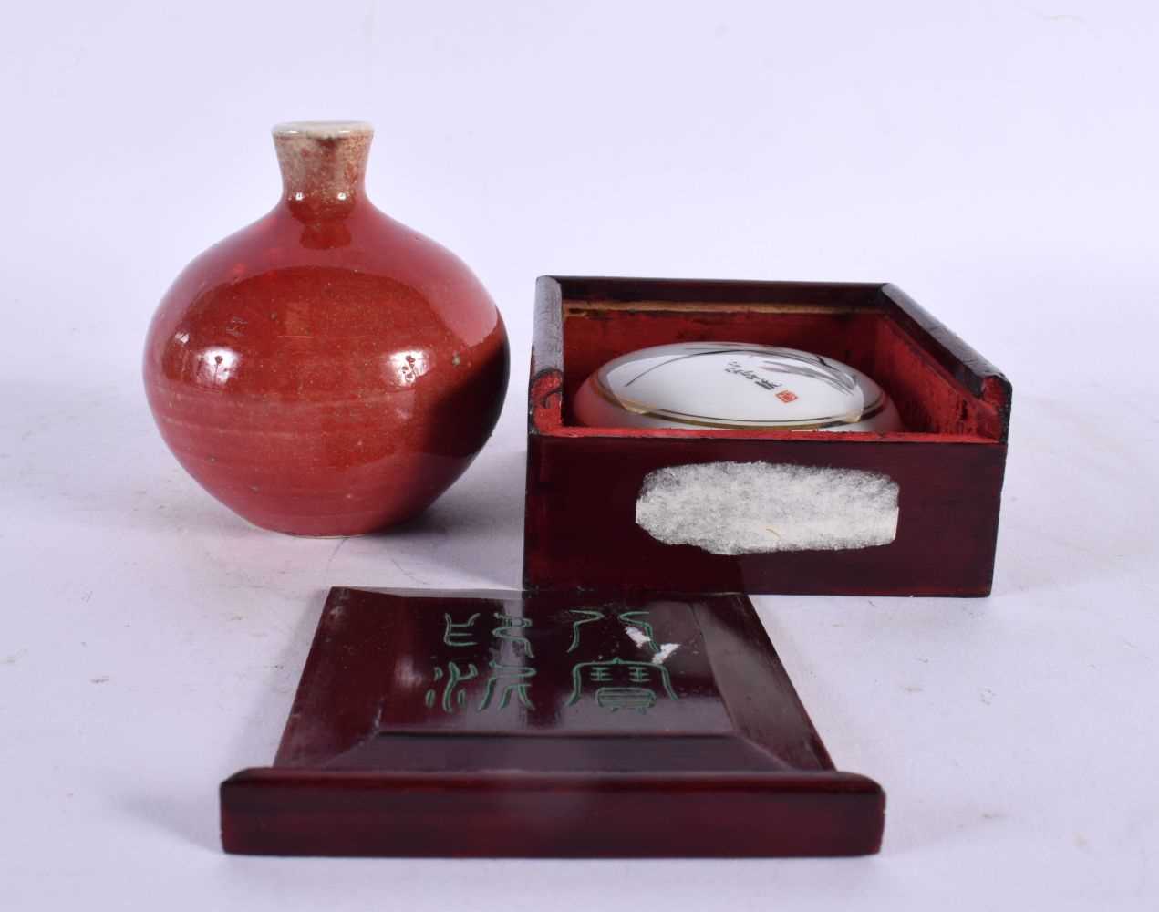 A SMALL CHINESE SANG DU BOEUF PORCELAIN VASE together with a porcelain ink box. (2)