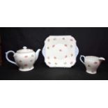 A Shelley ceramic teapot together with a milk jug and plate. 24 x 22cm (3).