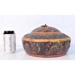 An antique Afghani wooden spice box decorated with metal flowers and painted with floral patterns.