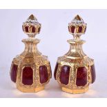 A FINE PAIR OF 19TH CENTURY BOHEMIAN RUBY AND GILT GLASS SCENT BOTTLES painted with motifs. 13 cm