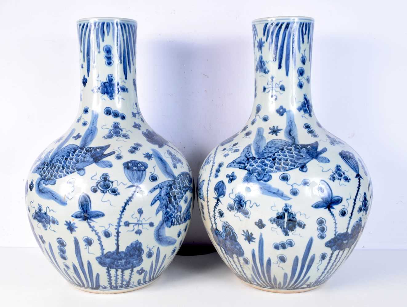 A large pair of blue and white porcelain vases decorated with fish. 59cm (2). - Bild 2 aus 3