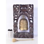 A Chinese Tibetan temple bell in a carved wood dragon frame inlaid with metal thread. 44 x 26cm.