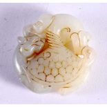 A CHINESE CARVED JADE ROUNDEL 20th Century. 5 cm wide.