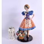 A LARGE 1950S ITALIAN CERAMIC FIGURE OF A STANDING FEMALE in the manner of Lenci. 34 cm x 13 cm.