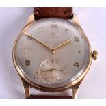 A 1950S OMEGA 9CT GOLD WRISTWATCH with silvered dial and smaller rotating minute hand. 3 cm diameter