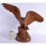 A LARGE 19TH CENTURY BAVARIAN BLACK FOREST CARVED WOOD FIGURE OF AN EAGLE bearing Swiss retailer