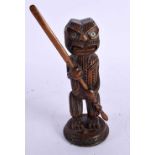 A SMALL EARLY 20TH CENTURY NEW ZEALAND CARVED MAORI FIGURE OF A GOD modelled holding a paddle, his