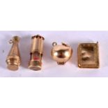 FOUR 9CT GOLD CHARMS MODELLED AS AN APPLE, A MINERS LAMP, AN EWER AND A BOOK. Largest 2cm, total