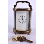 A MINIATURE CARRIAGE CLOCK, Working with keys, Height 11.5cm with handle extended x 6.3cm x 4.7cm