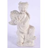 AN 18TH CENTURY CHINESE BLANC DE CHINE PORCELAIN FIGURE OF A YOUNG GIRL Qing, modelled holding aloft