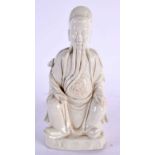 AN 18TH CENTURY CHINESE BLANC DE CHINE PORCELAIN FIGURE OF AN IMMORTAL Qing, modelled holding a
