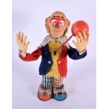 A VINTAGE JAPANESE CLOCKWORK TINPLATE CLOWN. 28 cm high.