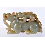 A GREEN JADE CARVING OF A TEMPLE DOG WITH A SMALLER DOG ON ITS BACK. 4.6cm x 8.1cm x 2.4cm, weight