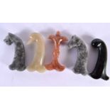 FIVE MIDDLE EASTERN CARVED AGATE HARDSTONE DAGGER HANDLES in various forms. 15 cm long. (5)