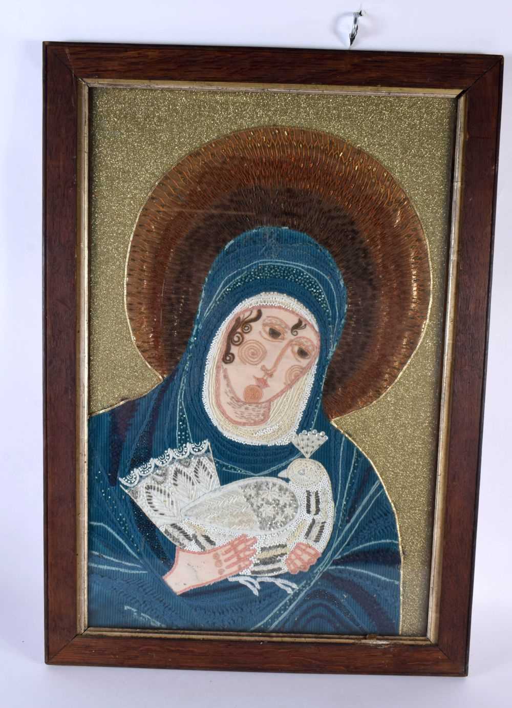 A RARE 19TH CENTURY EMBROIDERED PANEL OF A SAINT modelled holding a bird. 62 cm x 48 cm.