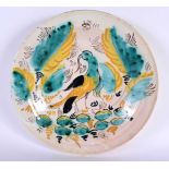 A CONTINENTAL DELFT FAIENCE TIN GLAZED POTTERY DISH painted with a stylised bird. 27 cm diameter.