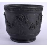 AN ANTIQUE WEDGWOOD BLACK BASALT JARDINIERE decorated with berries and vines. 15 cm x 13 cm.