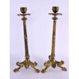 A PAIR OF 19TH CENTURY FRENCH BRONZE CANDLESTICKS formed with feet beside shells. 30 cm high.