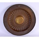 AN EARLY CONTINENTAL BRASS ALMS DISH. 40 cm diameter.