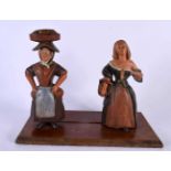 A 19TH CENTURY CONTINENTAL FOLK ART POTTERY SLIDING FIGURAL GROUP formed as two peasants. 24 cm x 27