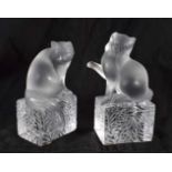 TWO FRENCH LALIQUE GLASS CATS modelled upon cracked ice type bases. Largest 15cm x 8cm. (2)