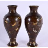A PAIR OF 19TH CENTURY JAPANESE MEIJI PERIOD GOLD AND SILVER ONLAID VASES decorated with birds in