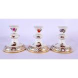 THREE 19TH CENTURY GERMAN MEISSEN STYLE PORCELAIN CANDLESTICKS painted with figures in landscapes.