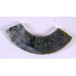 AN EARLY CHINESE CARVED ARCHAIC JADE AMULET of curving form. 10 cm wide.