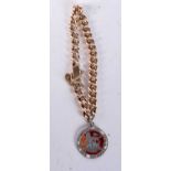 A CURB CHAIN BRACELET WITH AN ENAMELLED SHILLING PENDANT. Length 21cm, weight 18.1g