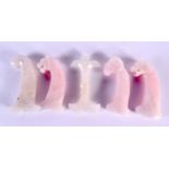 FIVE MIDDLE EASTERN CARVED ROSE QUARTZ HARDSTONE DAGGER HANDLES in various forms. 15 cm long. (5)