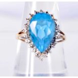 A 9CT GOLD RING SET WITH A TOPAZ SURROUNDED BY DIAMONDS. Size N, Stamped 9K, Topaz 14.5mm x 8.8mm,