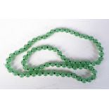 A GREEN JADE BEAD NECKLACE. Length 65cm, Bead size 8mm, weight 56.5g